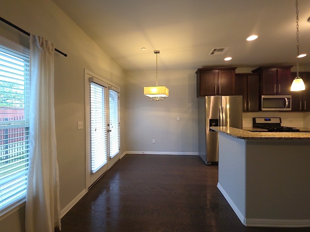 1608 Catalan Road, Unit 302 Austin, TX 78748 - Photo 6 of 21 a kitchen with stainless steel appliances granite countertop a refrigerator a sink a stove and a microwave