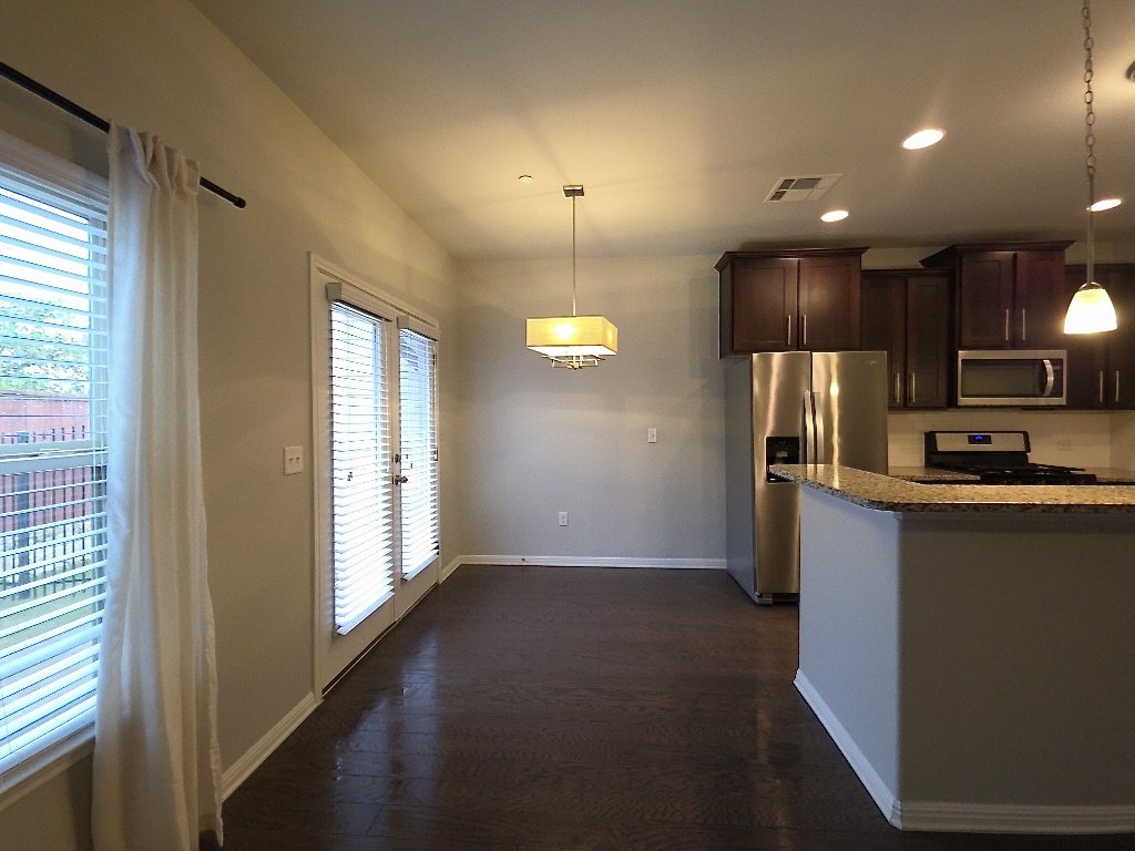1608 Catalan Road, Unit 302 Austin, TX 78748 - Photo 6 of 21 a kitchen with stainless steel appliances granite countertop a refrigerator a sink a stove and a microwave