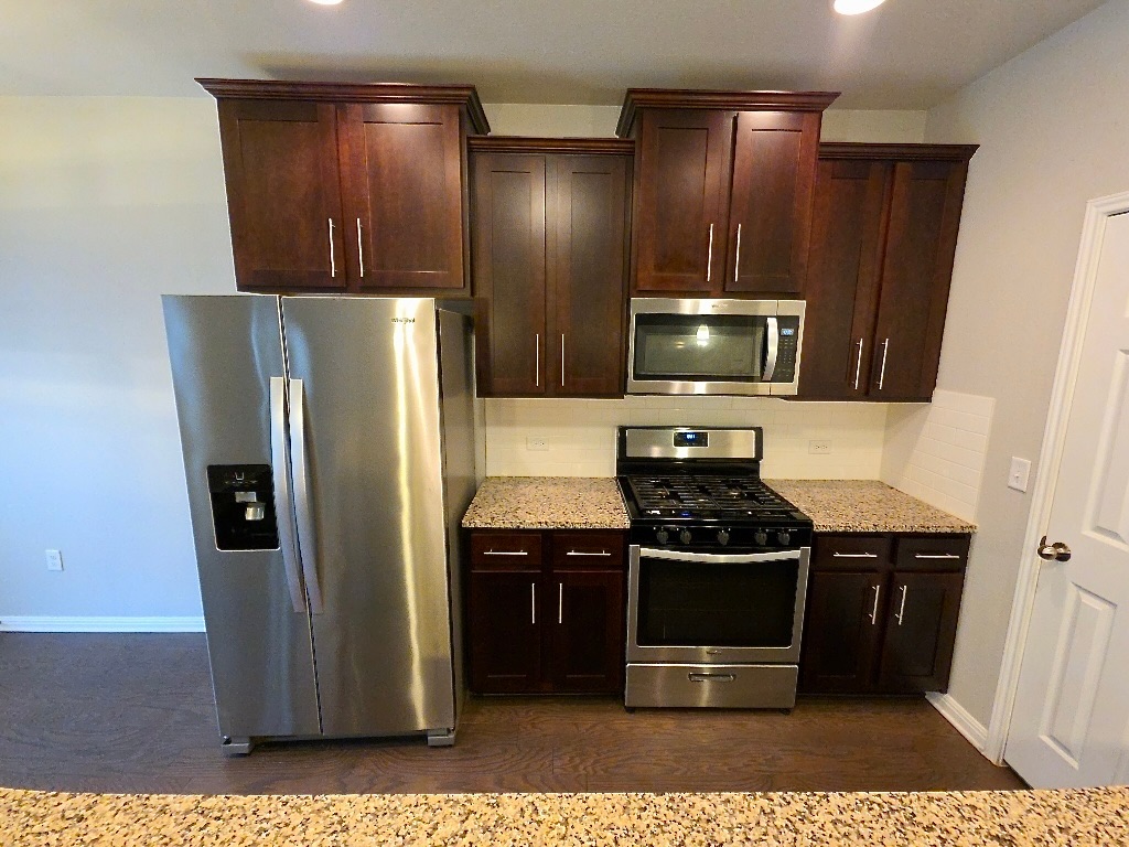 1608 Catalan Road, Unit 302 Austin, TX 78748 - Photo 7 of 21 a kitchen with stainless steel appliances a refrigerator and a stove