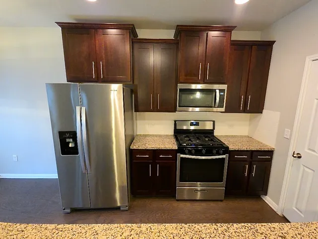 a kitchen with stainless steel appliances a refrigerator and a stove