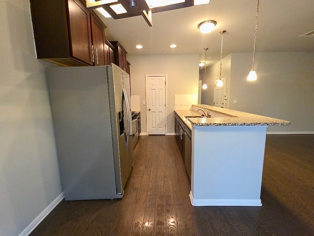 1608 Catalan Road, Unit 302 Austin, TX 78748 - Photo 8 of 21 a room with wooden floor and staircase