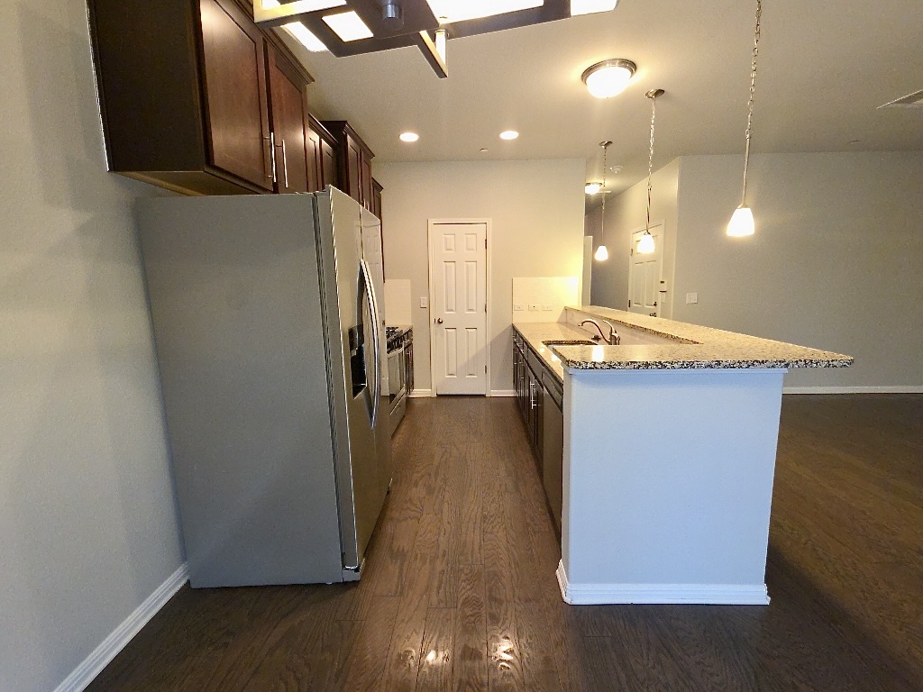 1608 Catalan Road, Unit 302 Austin, TX 78748 - Photo 8 of 21 a room with wooden floor and staircase