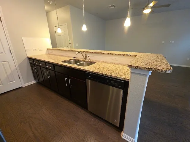 a bathroom with a granite countertop sink a vanity and a mirror