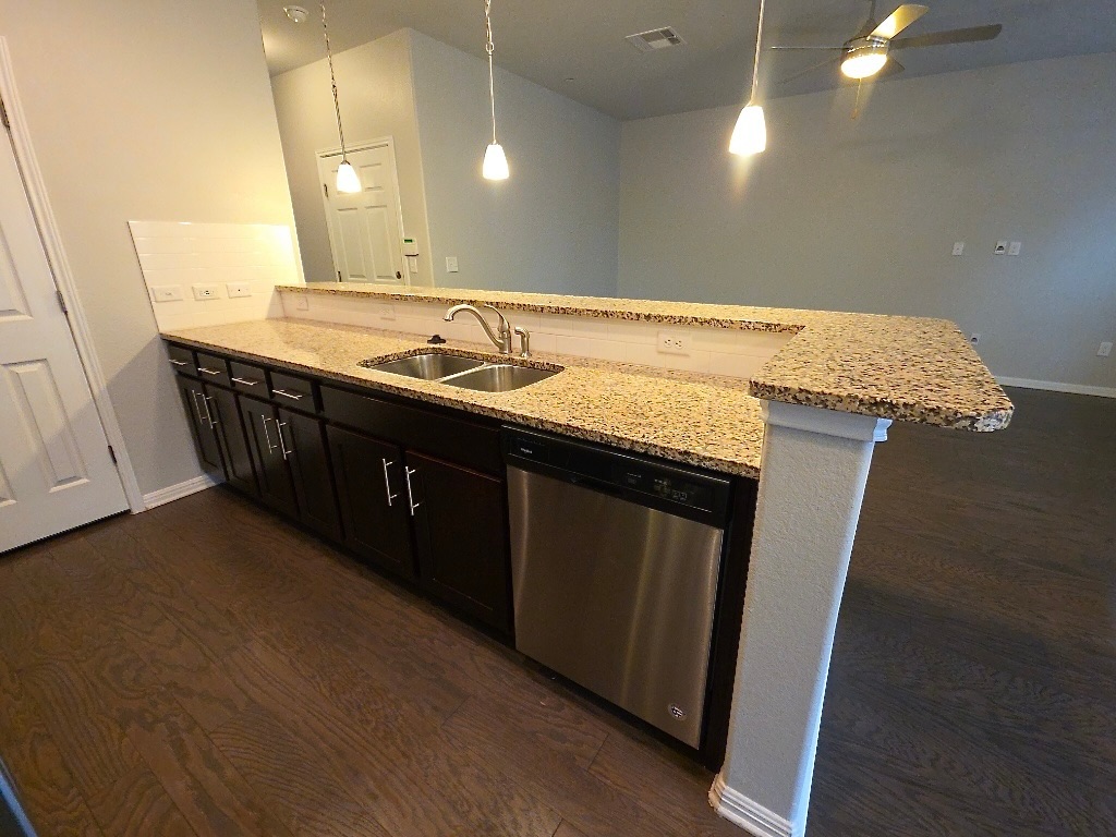 1608 Catalan Road, Unit 302 Austin, TX 78748 - Photo 9 of 21 a bathroom with a granite countertop sink a vanity and a mirror