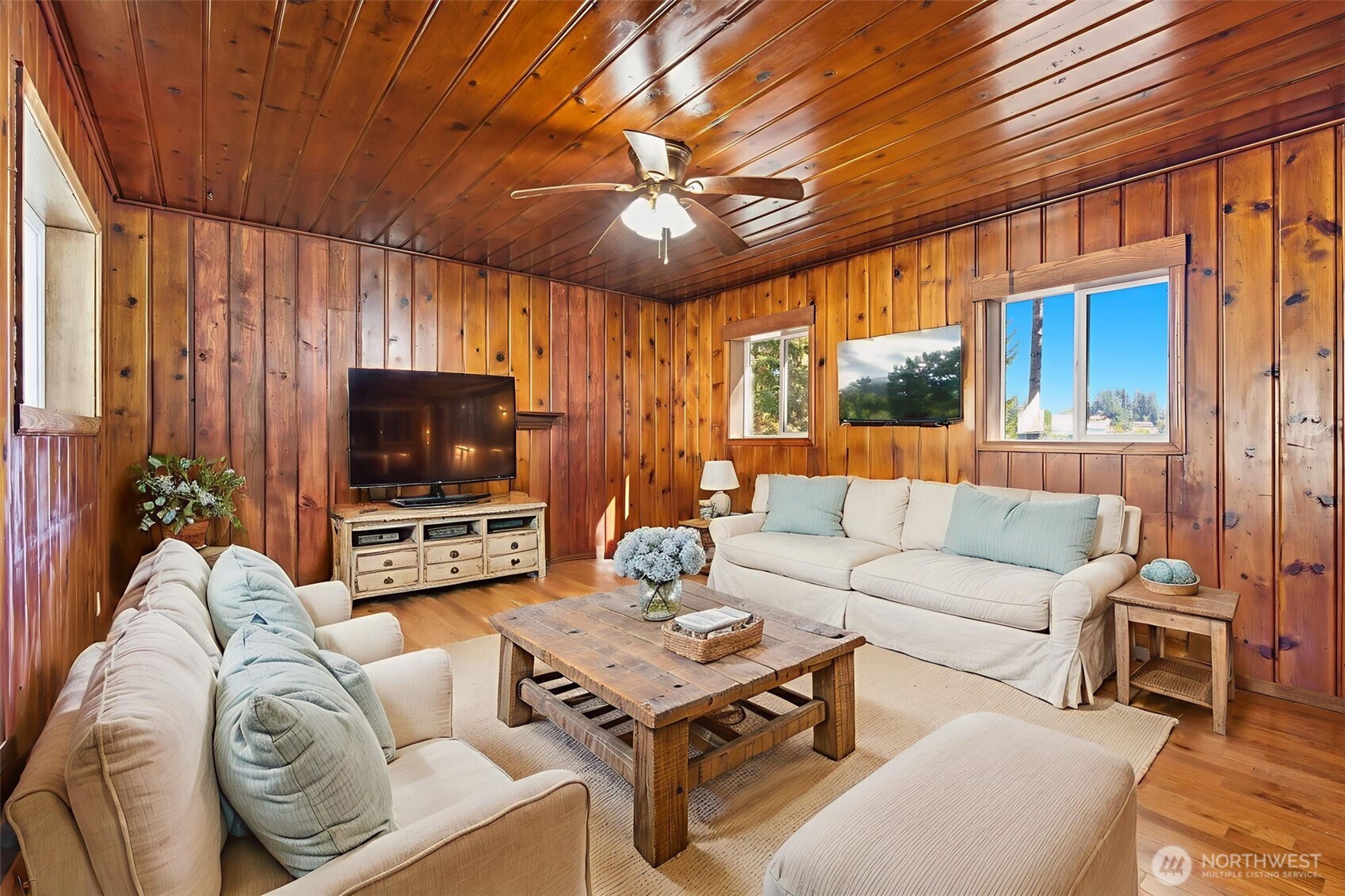 20310 Northwest Cedar Lane Poulsbo, WA 98370 - Photo 2 of 31 a living room with furniture a ceiling fan and a flat screen tv