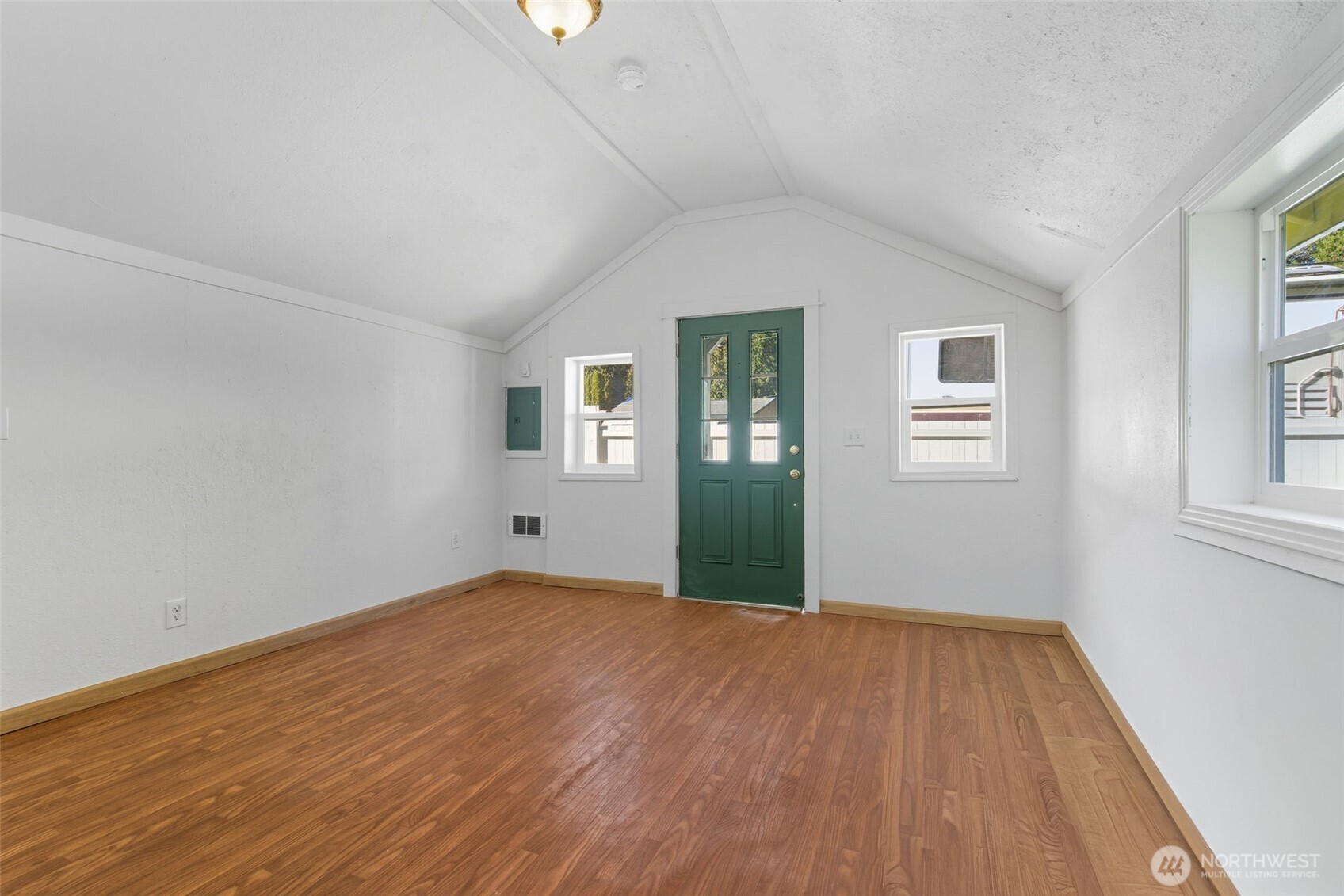 20310 Northwest Cedar Lane Poulsbo, WA 98370 - Photo 28 of 31 a view of an empty room with wooden floor and a window