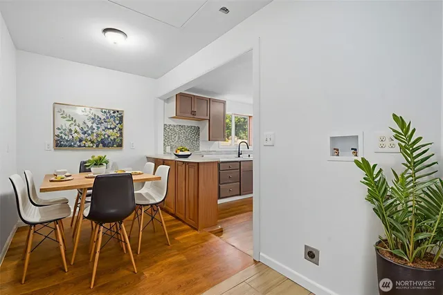 a dining room with furniture and wooden floor