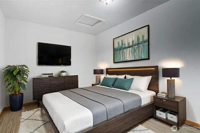 a bedroom with a bed and a flat screen tv