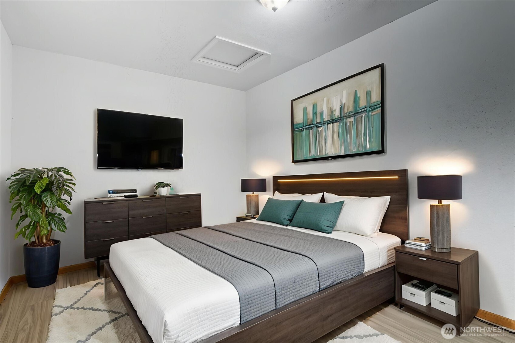 20310 Northwest Cedar Lane Poulsbo, WA 98370 - Photo 8 of 31 a bedroom with a bed and a flat screen tv