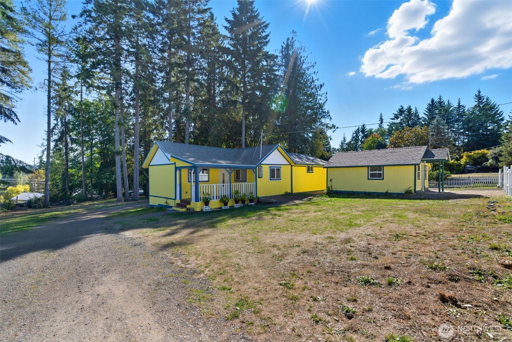20310 Northwest Cedar Lane Poulsbo, WA 98370 - Photo 10 of 31 a front view of a house with a yard and trees