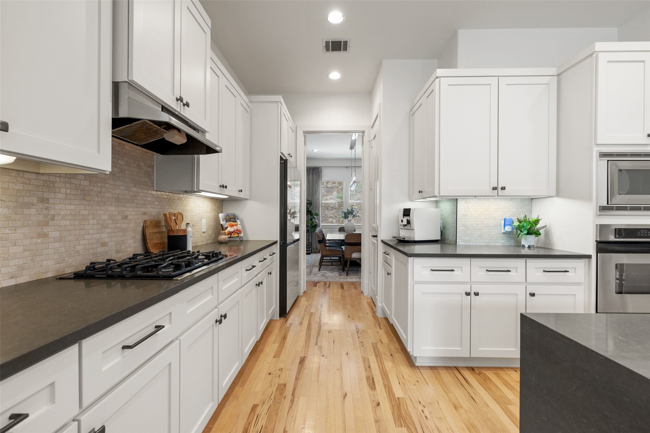 1529 Barton Springs Road, Unit 2 Austin, TX 78704 - Photo 12 of 40 a large kitchen with stainless steel appliances granite countertop a lot of counter space and wooden floors