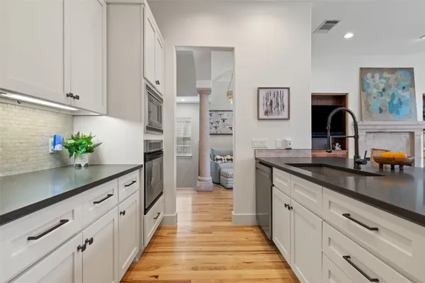 a kitchen with granite countertop a sink and cabinets