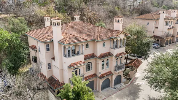 an aerial view of a house with a yard