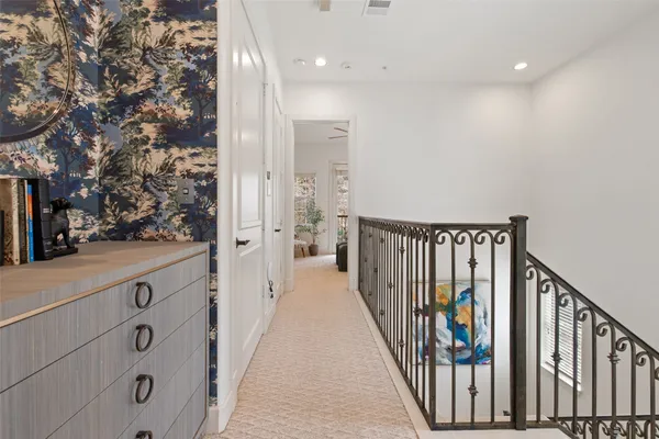 an entryway with a mirror and vanity
