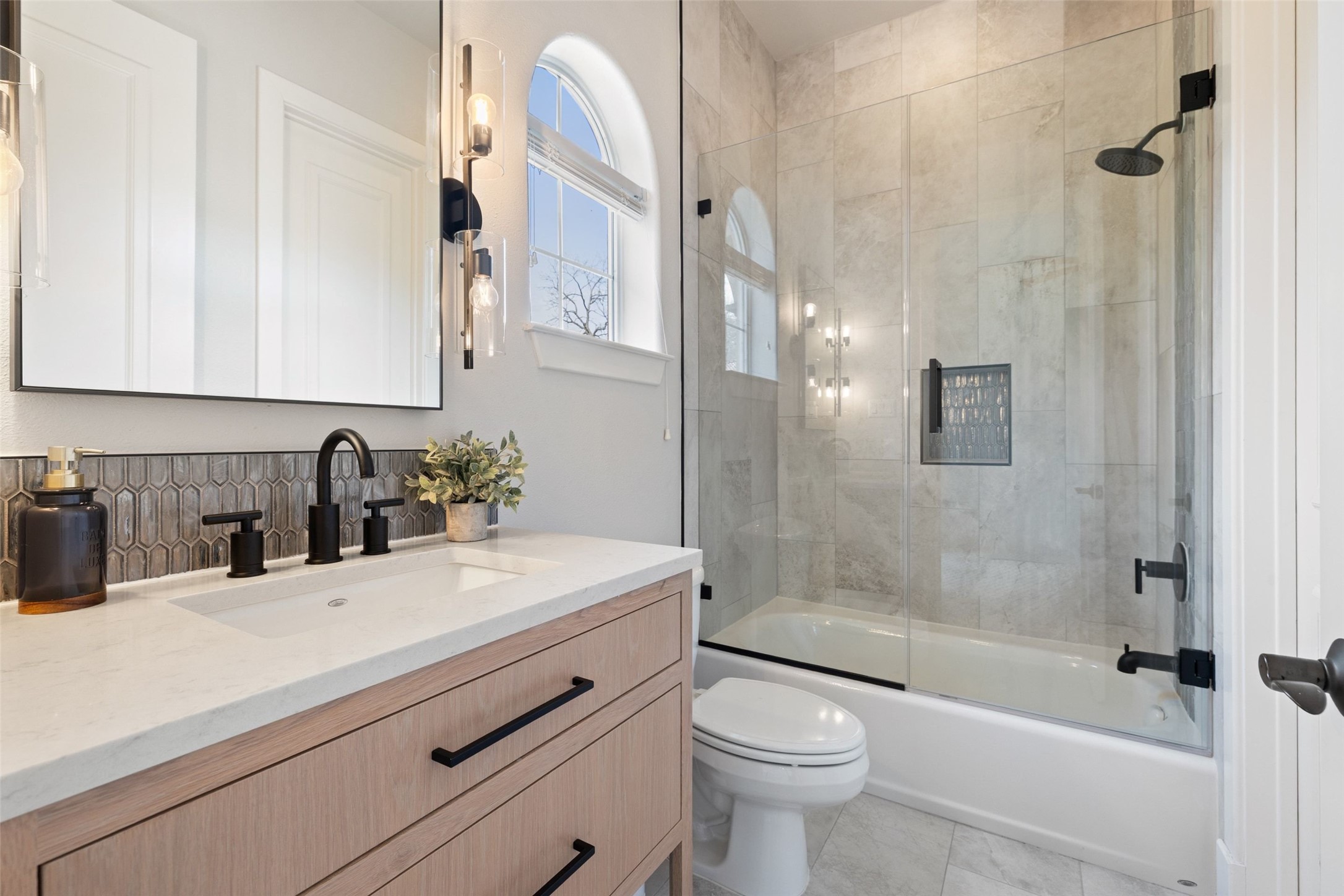 1529 Barton Springs Road, Unit 2 Austin, TX 78704 - Photo 34 of 40 a bathroom with a sink a toilet and shower