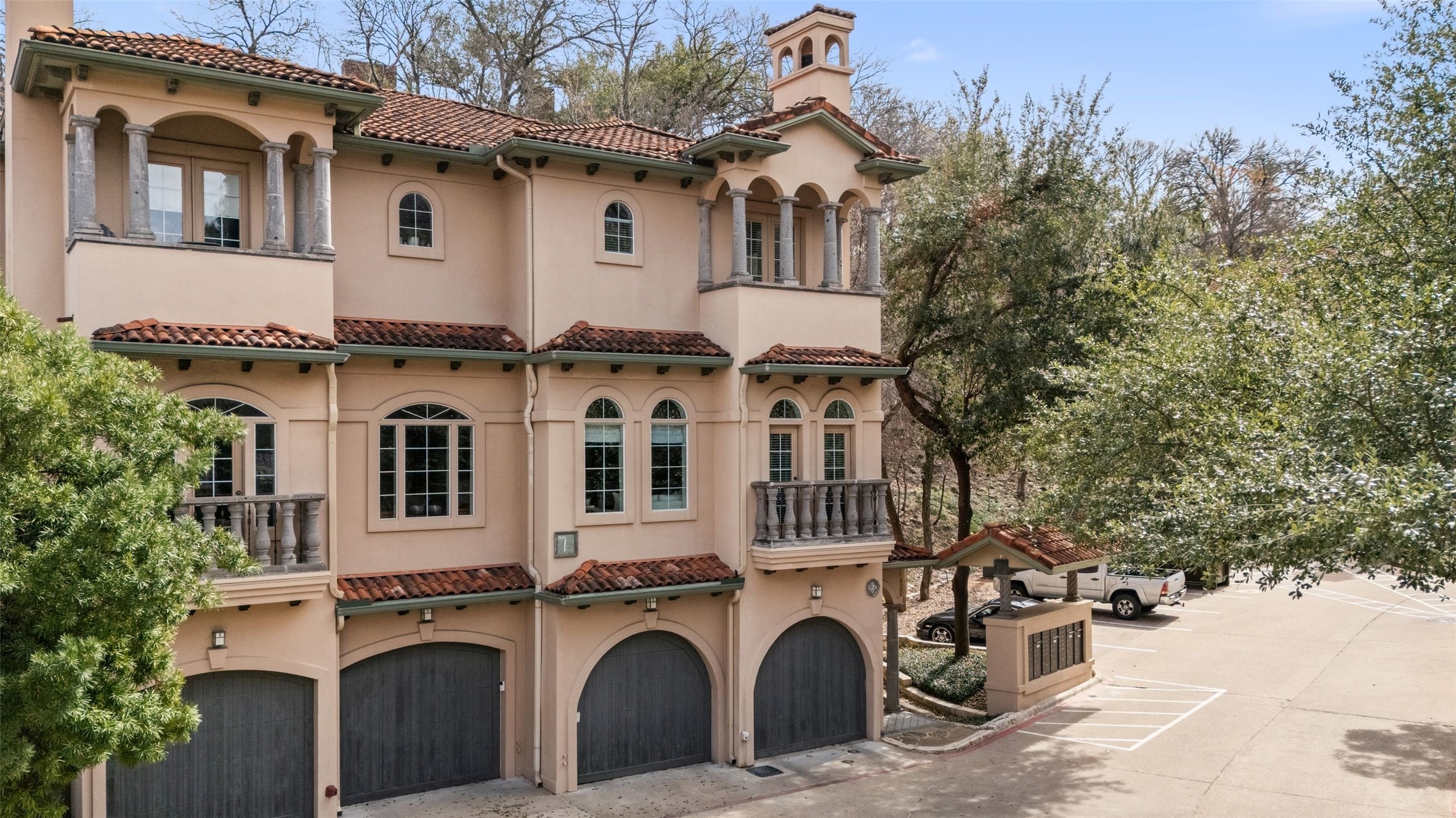1529 Barton Springs Road, Unit 2 Austin, TX 78704 - Photo 35 of 40 a view of a white house with large windows and a tree