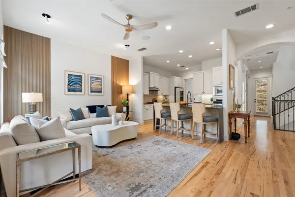 a living room with lots of furniture and kitchen view