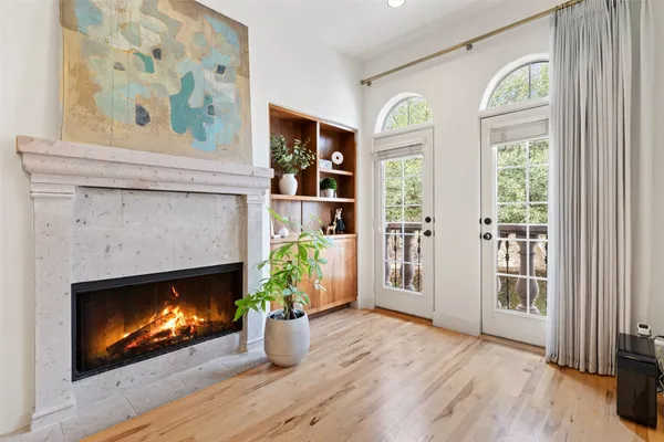 a view of an empty room with window and fire place