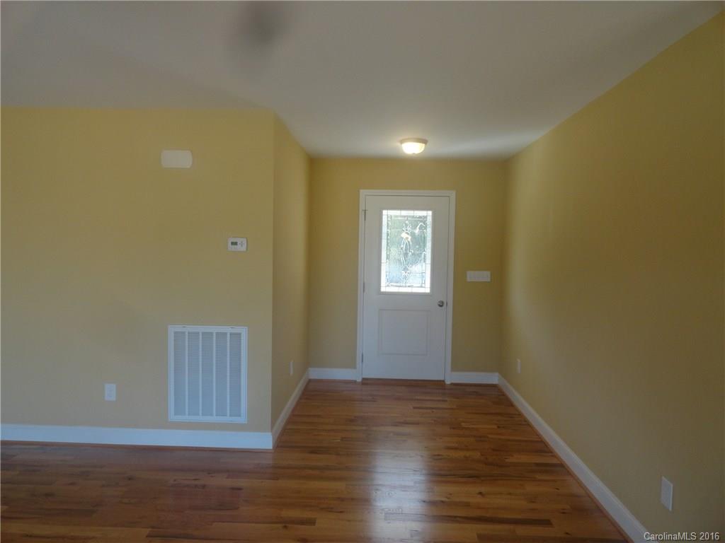 4759 Kemp Dellinger Road, Unit 1 Maiden, NC 28650 - Photo 2 of 24 a view of an empty room with wooden floor and a window