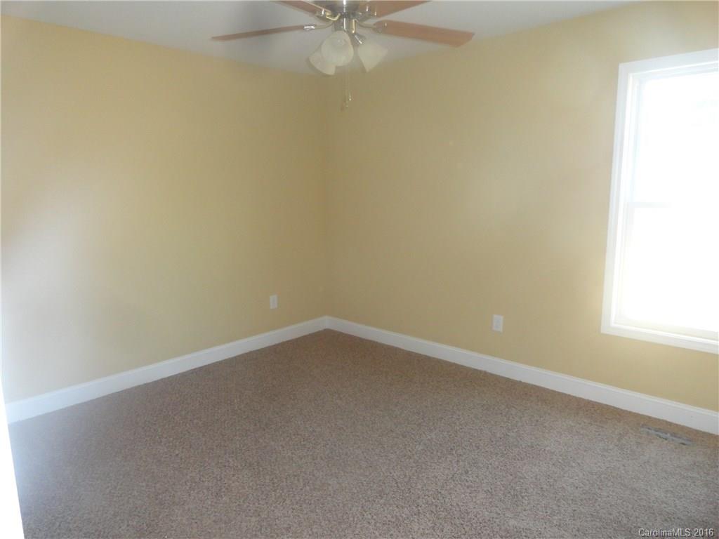 4759 Kemp Dellinger Road, Unit 1 Maiden, NC 28650 - Photo 13 of 24 an empty room with a window and a fan