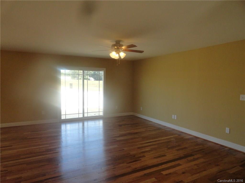 4759 Kemp Dellinger Road, Unit 1 Maiden, NC 28650 - Photo 3 of 24 a view of wooden floor and chandelier fan in a room