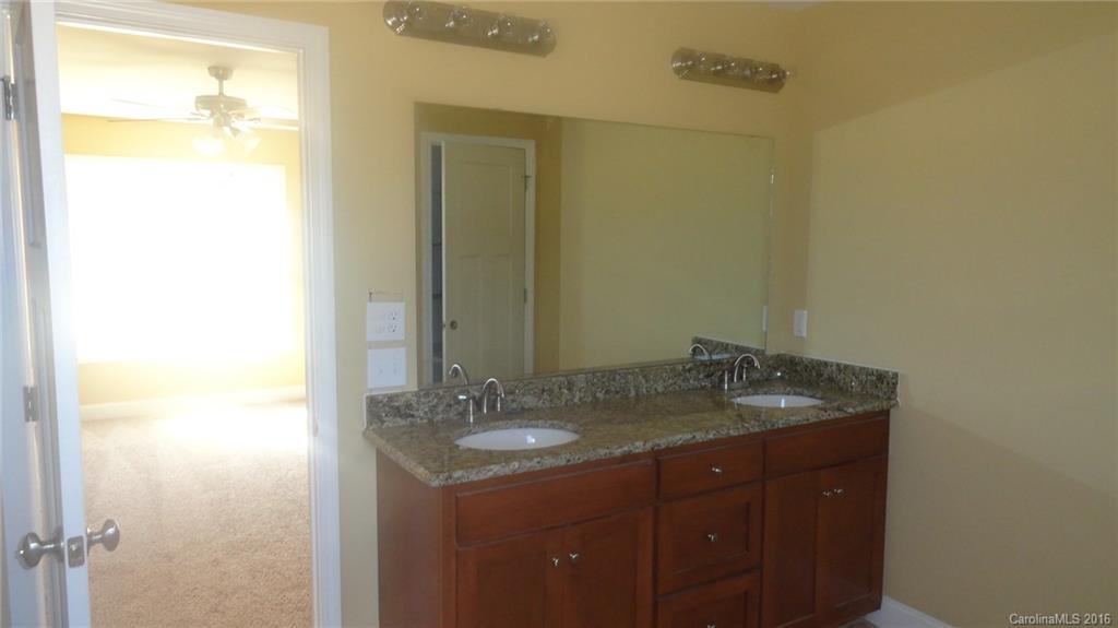 4759 Kemp Dellinger Road, Unit 1 Maiden, NC 28650 - Photo 21 of 24 a bathroom with a granite countertop sink and a mirror