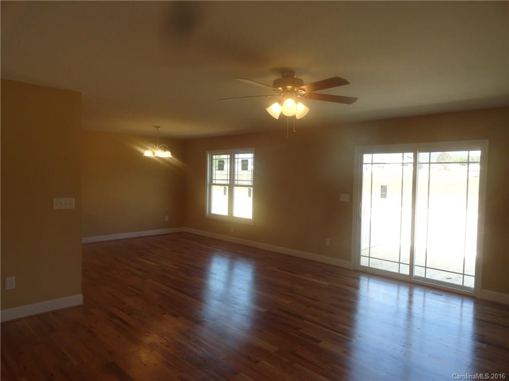 4759 Kemp Dellinger Road, Unit 1 Maiden, NC 28650 - Photo 4 of 24 a view of empty room with wooden floor and fan