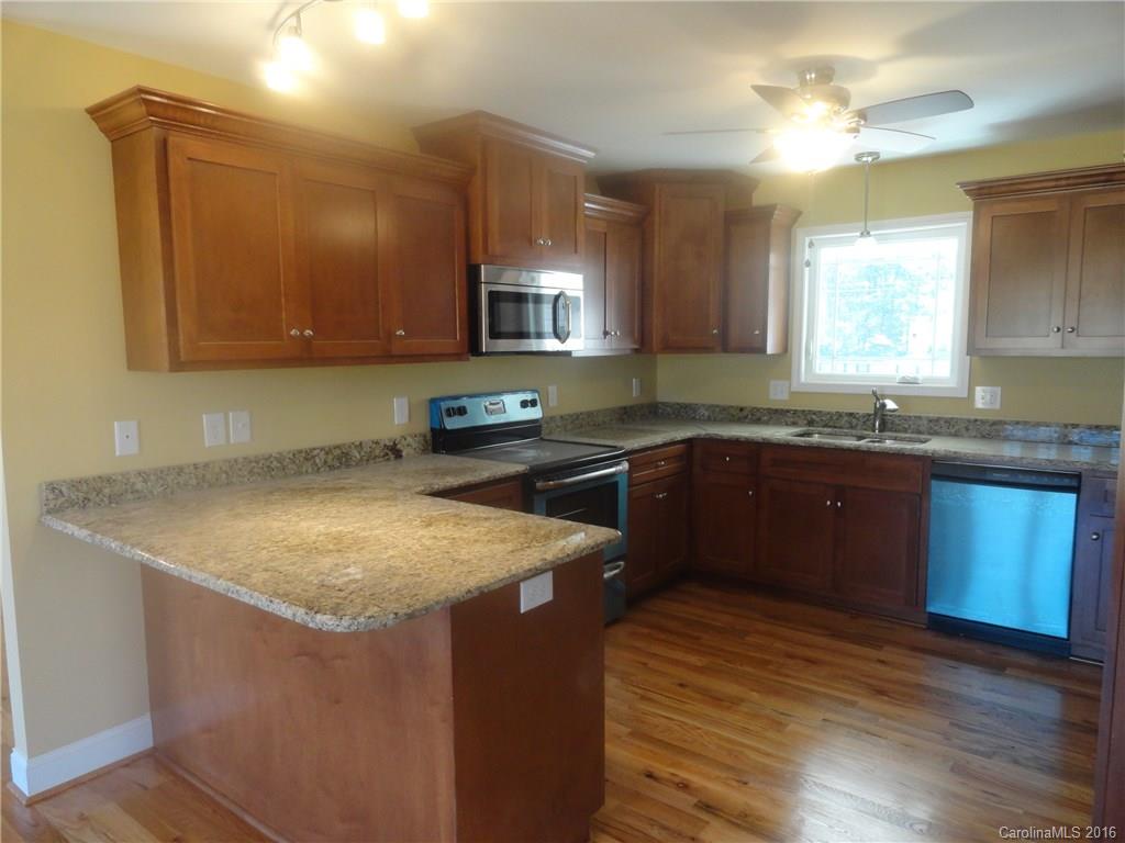 4759 Kemp Dellinger Road, Unit 1 Maiden, NC 28650 - Photo 9 of 24 a kitchen with granite countertop a sink a counter top space and cabinets