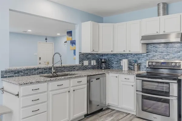 a kitchen with a refrigerator and cabinets