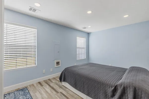 a bedroom with a bed and a mirror