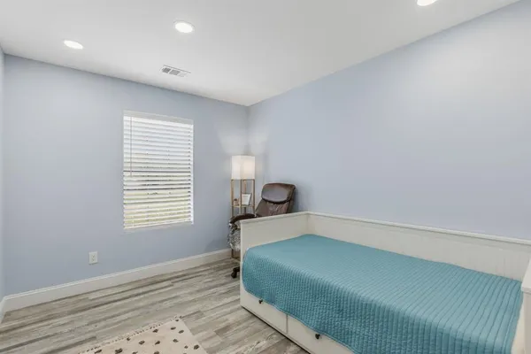 a bedroom with a bed and a chair