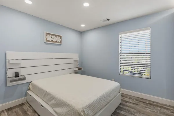 a bedroom with a bed and a wall painting