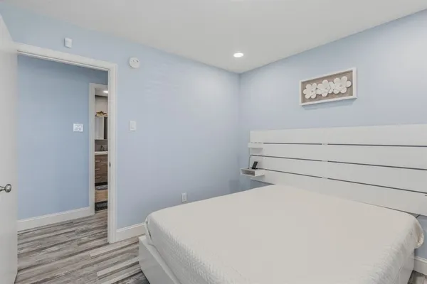 a bathroom with a toilet sink vanity and mirror