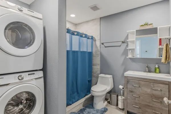a bathroom with a toilet a sink and shower