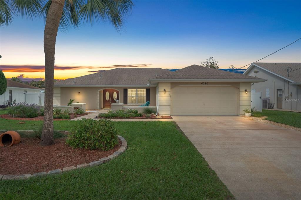 4297 Everett Avenue Spring Hill, FL 34609 - Photo 1 of 1 a front view of a house with a garden