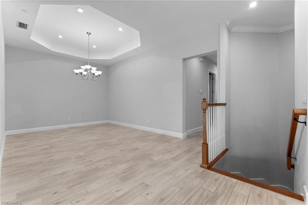 15244 Zeno Way, Unit 201 Naples, FL 34114 - Photo 15 of 50 a view of empty room with wooden floor