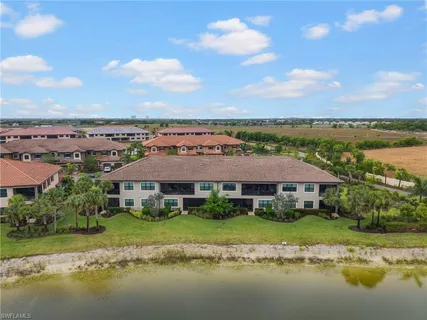 a view of a lake with a big yard and large trees