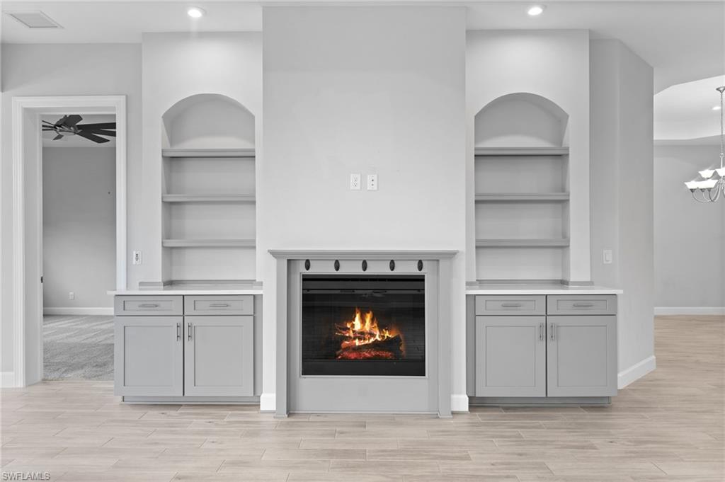 15244 Zeno Way, Unit 201 Naples, FL 34114 - Photo 24 of 50 a living room with furniture and a fireplace