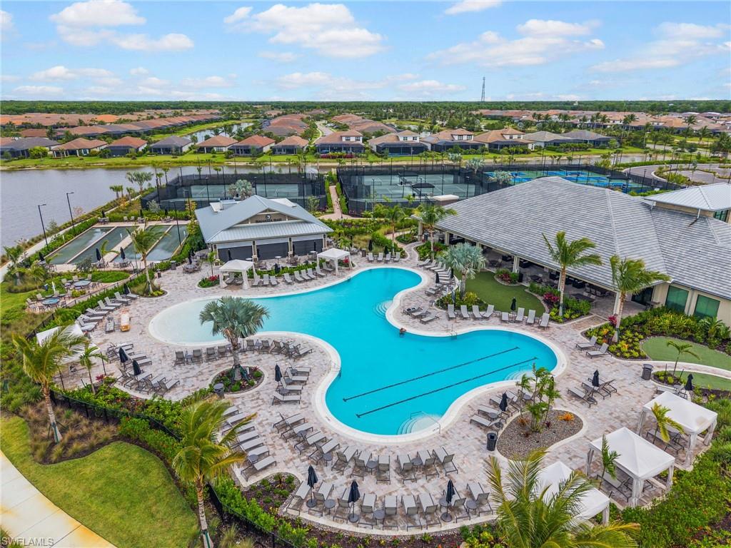 15244 Zeno Way, Unit 201 Naples, FL 34114 - Photo 39 of 50 a view of a swimming pool with lounge chairs