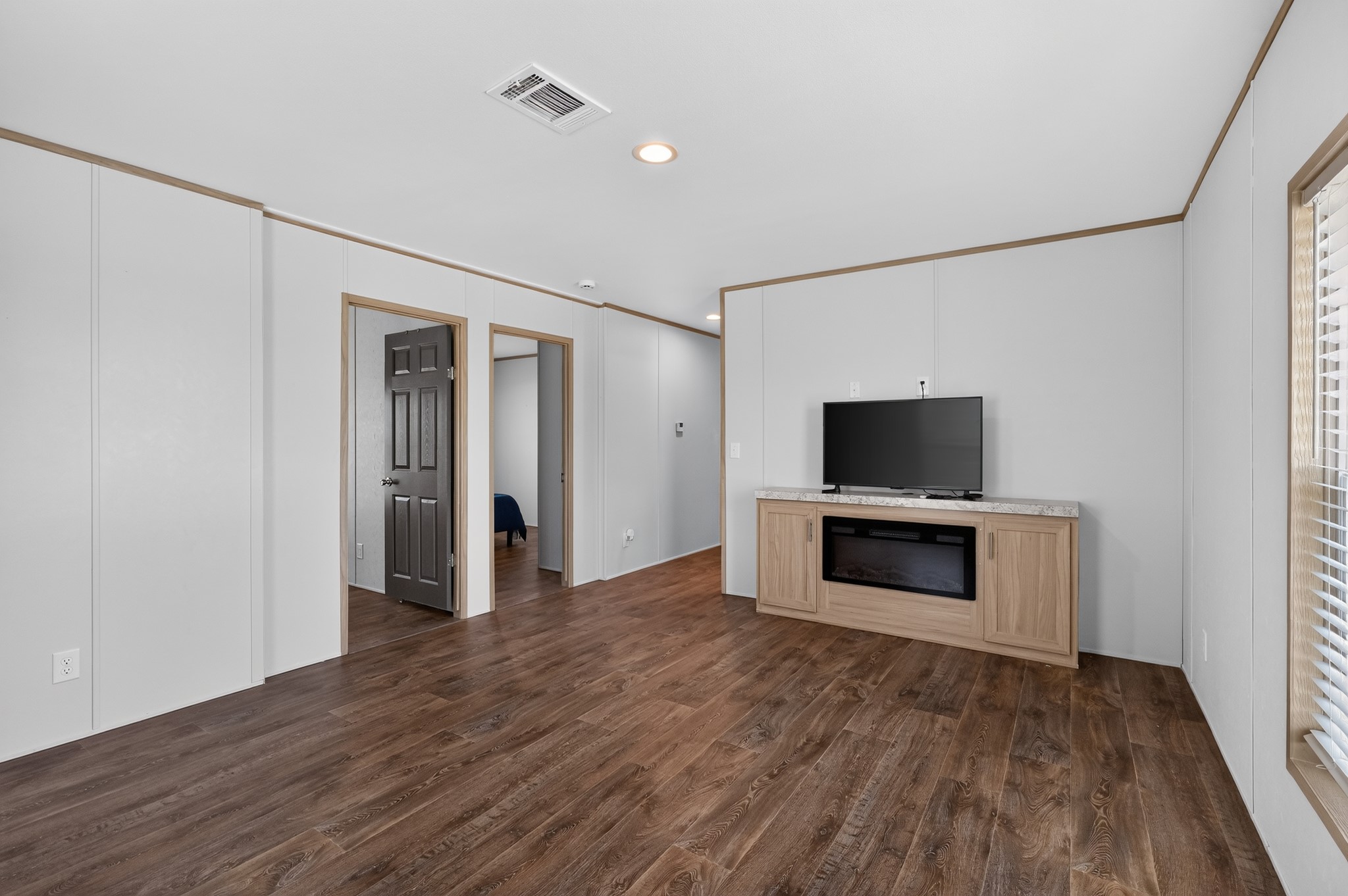1134 Switchgrass Road Salado, TX 76571 - Photo 13 of 28 Laminate flooring extends throughout this naturally illuminated living space, featuring an entertainment center with an electric fireplace.