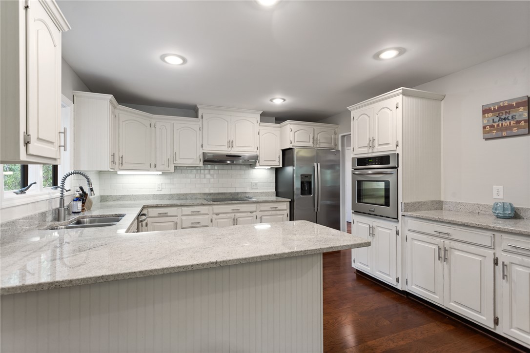 5 High Tide Court Salem, SC 29676 - Photo 8 of 40 This bright kitchen features ample counter space, modern appliances, and rich wood flooring.