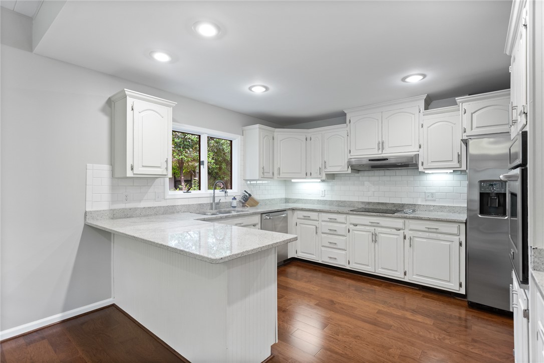 5 High Tide Court Salem, SC 29676 - Photo 9 of 40 This bright kitchen features ample counter space, modern appliances, and beautiful hardwood flooring.