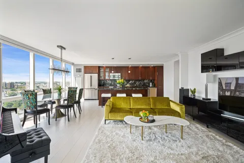 a living room with furniture dining table and a flat screen tv