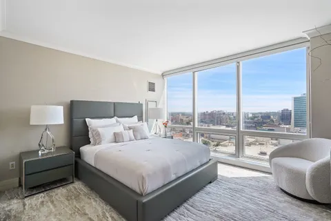 a bedroom with a large bed and a large window