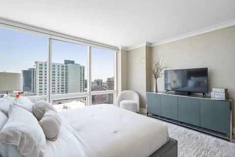 a bedroom with furniture and a flat screen tv