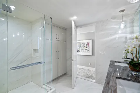 a bathroom with a tub shower and sink
