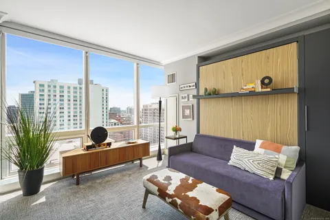 a living room with furniture and a large window