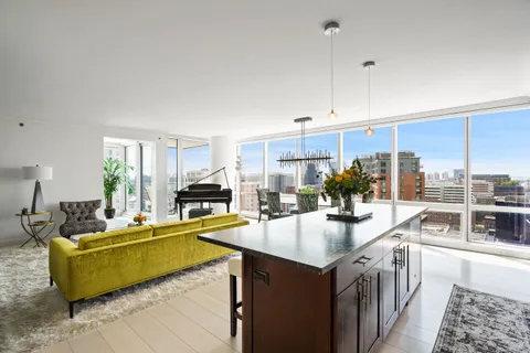a kitchen with sink cabinets and living room view