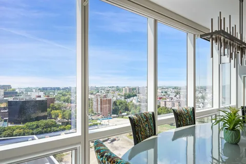 a view of a room with a large window and furniture