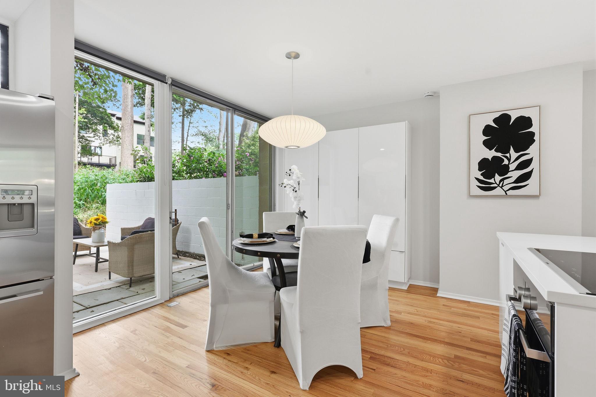 11510 Maple Ridge Road Reston, VA 20190 - Photo 16 of 43 a view of a dining room with furniture window and wooden floor